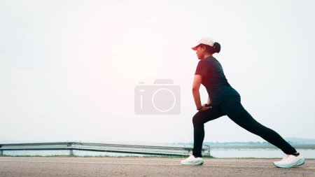Women warm up before running on the road, sets new goal to start running exercise, selective and soft focus.