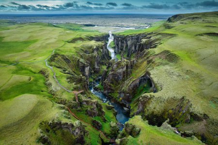 Téléchargez les photos : Stunning aerial view of Fjadrargljufur canyon naturally eroded with Fjadra flowing through ravine in summer at Iceland - en image libre de droit