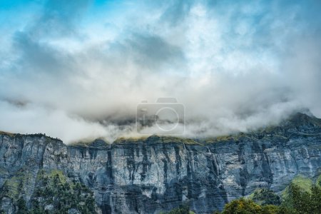 Photo for Majestic landscape of Giffre valley of mountain range with cascade and foggy in the evening at Sixt Fer a Cheval, French Alps, France - Royalty Free Image