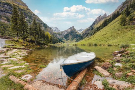 Beautiful view of Seealpsee mountain lake and boat in Alpstein mountain range on summer at Appenzell, Switzerland 