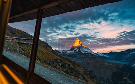Sunrise alpenglow on Matterhorn iconic mountain of Swiss Alps in the dawn at Zermatt, Switzerland