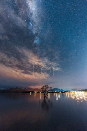 Photo for Beautiful view of Milky way over Willow tree in the night at Lake Wanaka, New Zealand - Royalty Free Image