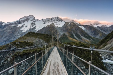 View of suspension bridge with Mt Cook mountain range on Hooker Valley track at national park, New Zealand