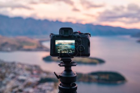 Set up a time lapse on camera at the viewpoint of Queenstown and Lake Wakatipu and Skyline Gondola at New Zealand 