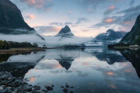 Mysterious landscape of Milford Sound or Rahotu with Mitre peak and foggy on the lake at Fjordland national park, New Zealand