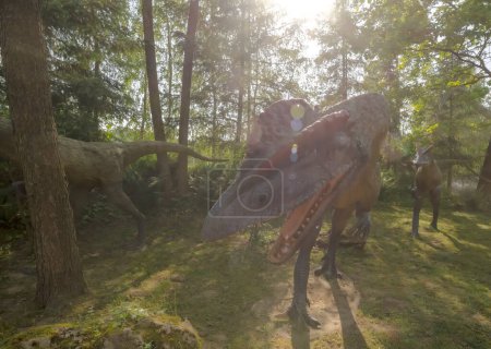Photo for Poland Baltow May 30, 2023 at 15:59 . Dilophosaurs on a hunting expedition in spring .A group of crested predatory dinosaurs in the afternoon sun (one became dangerously interested in the photographer) .Sculptures of prehistoric dromaeosaurs . - Royalty Free Image
