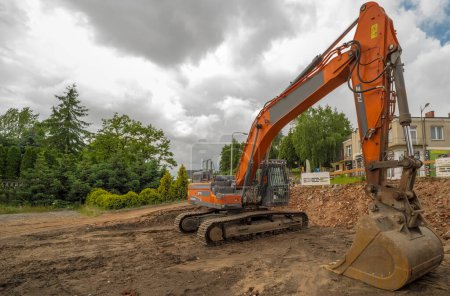 Photo for Poland Ostrowiec Swietokrzyski June 10, 2023 at 11:17. Doosan large crawler excavator at demolition.The ator is working in the construction site.Doosan DX340LC . Above, a dramatically and dynamically overcast spring sky. - Royalty Free Image