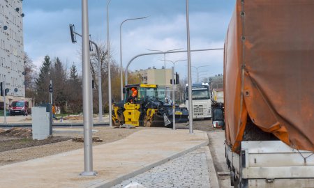 Photo for Poland Ostrowiec Swietokrzyski February 26, 2024 at 1:06 p.m. The heavy Bomag road roller is working to compact the asphalt . Pouring asphalt surface on a newly built road in the city - Roller compacts a layer of fresh asphalt. - Royalty Free Image