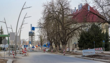 Construction of a new building in the city.The main avenue of the city is being renovated, a new bridge under construction is visible in the background. Newly built bridge and street (May 3rd Avenue) on a spring day under a grayish sky.  