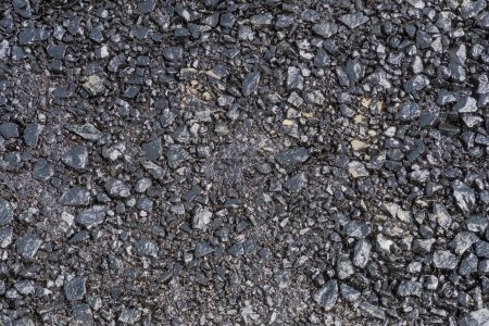 Textura de asfalto. Fondo de asfalto.Primera capa de asfalto recién compactada. Verter la primera capa básica de asfalto en el sitio de construcción de una nueva carretera .  