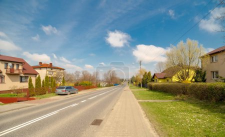 View of the street of old town of Szewna, of Poland.Spring in the hills near Ostrowiec  under a blue sky. A road running through the neighboring town just before Ostrowiec. Beautiful sky with delicate clouds . 