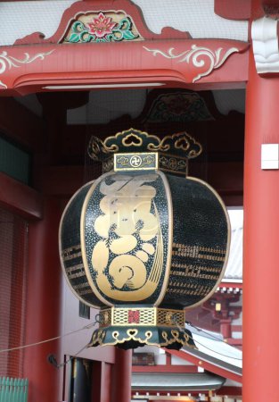 Photo for Tokyo, Japan - March 2, 2024: closeup of one of  the black side lantern hanging in the Hozomon translated Treasure-House Gate close to the Sensoji Temple - Royalty Free Image