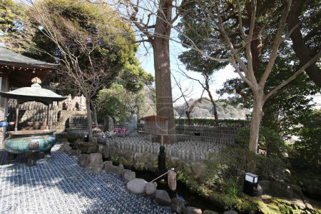 Kamakura, Japan -March 4, 2024: Upper level of the Hase-kannon temple complex side with Japanese Koro or insent burner and jizo statues