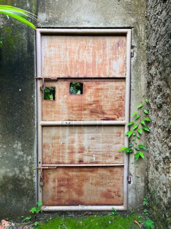 Abandoned rusty doors and mossy walls