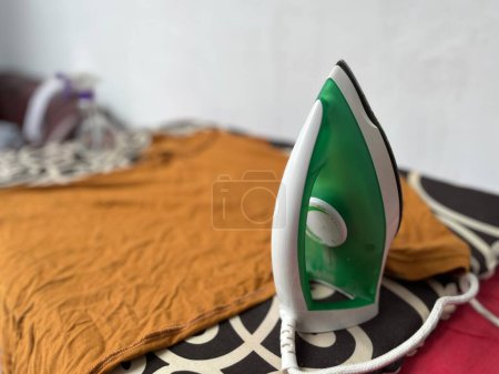 Ironing men's clothes and giving them clothes freshener to make them fragrant and smooth