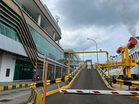 Yellow ship bridge with black yellow lines and car parking space inside the ship