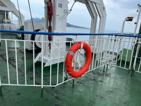 The ship's ring buoy hangs on the iron railing for emergencies if an accident occurs