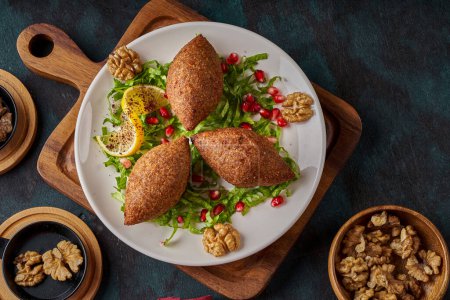 Photo for A plate of oriental fried kibbeh on a wooden floor - Royalty Free Image