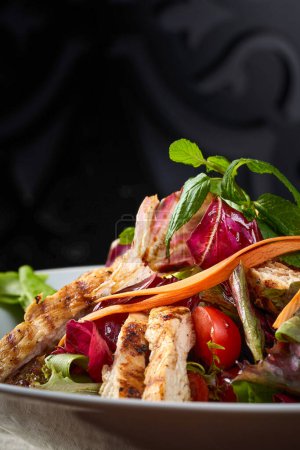 Photo for Close up of leafy greens salad with chicken - Royalty Free Image