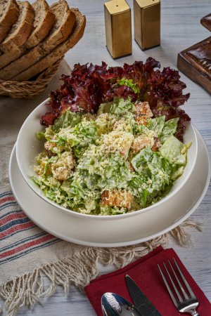 Photo for Chicken Caesar salad plate on a wooden floor - Royalty Free Image
