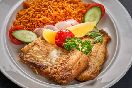 Photo for A close-up of A dish of fried fish with rice and vegetables - Royalty Free Image