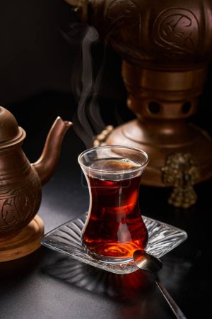 Turkish tea cup with copper utensils and teapot