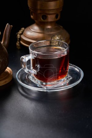 Turkish tea cup with copper utensils and teapot