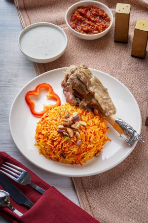 Mandi rice dish with grilled lamb leg