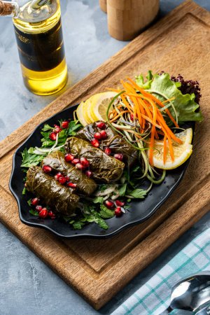 Photo for Grape leaves rolls stuffed with rice and meat, a popular Turkish-Arab appetizer dish - Royalty Free Image