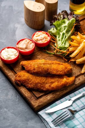 Photo for Chicken escalope meal with sauce, vegetables and french fries - Royalty Free Image