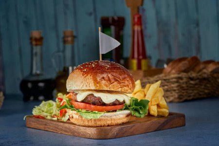 Photo for Burger with meat, mushrooms and onions with French fries - Royalty Free Image