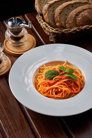 Photo for Bolognese pasta dish with wheat bread in the background - Royalty Free Image