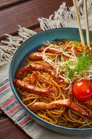 Photo for Close-up of a bowl of noodles with chicken with herbs - Royalty Free Image
