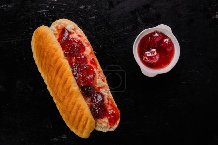 Téléchargez les photos : Photo de vue du dessus du sandwich à la confiture de fraises sur fond noir - en image libre de droit
