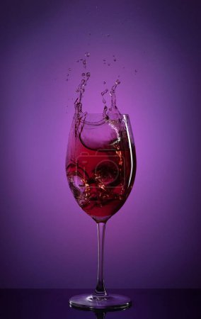 Photo for Glass of red wine with splash - Royalty Free Image