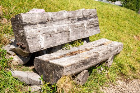 Old beautiful wood bench in the Swiss alps made of old tree trunks