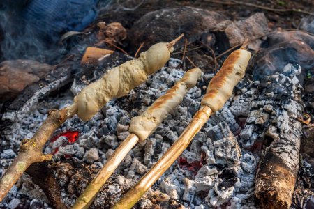 bonfire with bread on a stick