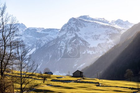 View of the Alps in Glarus, Switzerland, on a sunset evening wit