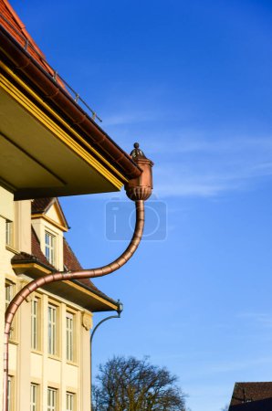 Vintage gutter on an old school building in Switzerland
