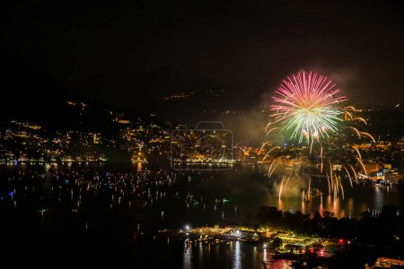 fireworks at the lake of lugano during the swiss national day celebration