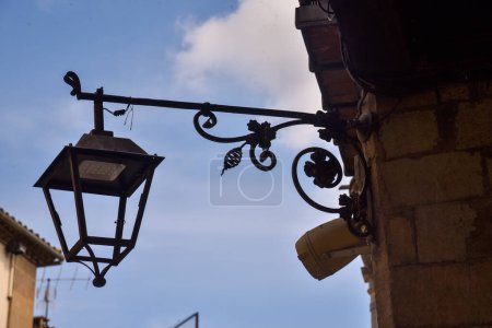 Photo for Old lamp structure with new led light incorporated in an old medieval town in spain - Royalty Free Image