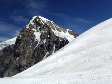 Una montaña nevada en Suiza contra un cielo azul claro