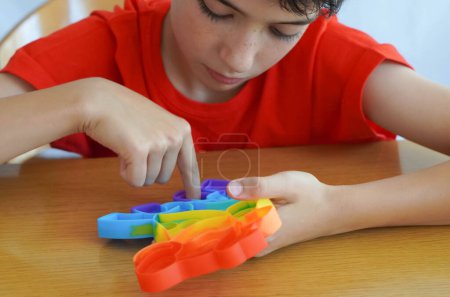 child using anti-stress toy, to improve attention and concentration. ADHD concept