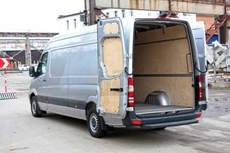 Photo for Van Cargo open trunk in the city street. Open van body. Van Cargo open door trunk. Cargo van ready to load cargo. Start Loading Delivery Truck. Delivery of goods. - Royalty Free Image