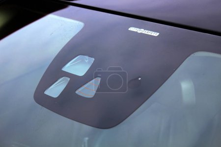 Rain and headlight sensors on a cars windshield. Car Anti Collision Sensor System vehicle tracking system.