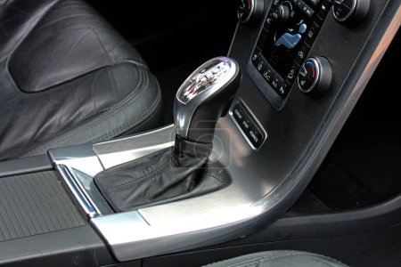 Automatic gear stick inside modern car. Automatic gearbox lever. Detail on a automatic gear shifter in a car.
