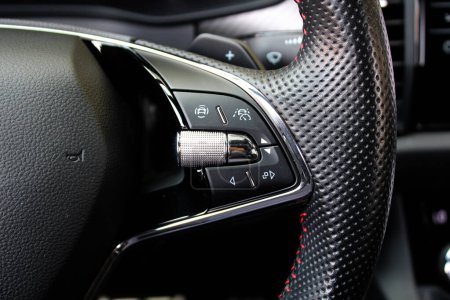 Close up image of car steering wheel with function buttons. Sport car steering wheel. Sport car interior. Function Buttons on car steering wheel. Right side.
