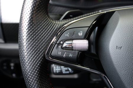 Close up image of car steering wheel with function buttons. Sport car steering wheel. Sport car interior. Function Buttons on car steering wheel. Left side.