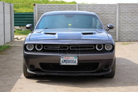 Photo for Vinnytsia, Ukraine; April 13, 2024. Grey Dodge Challenger  at the city street. American supercharged muscle car Dodge Challenger at the parking. Front view. - Royalty Free Image
