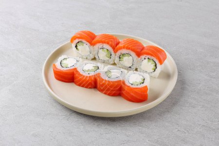 Sushi delivery. Set of rolls in a disposable box on a black background